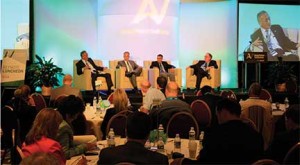 Automotive journalist Lindsay Chappell, right, conducts an AutoVision conference discussion of “The Next 10 Years in the Auto Industry” with, from left, Yoshimasa Ogino of Akebono Brakes, Chris Nielsen of Toyota, and Tom Kroskey of General Motors.