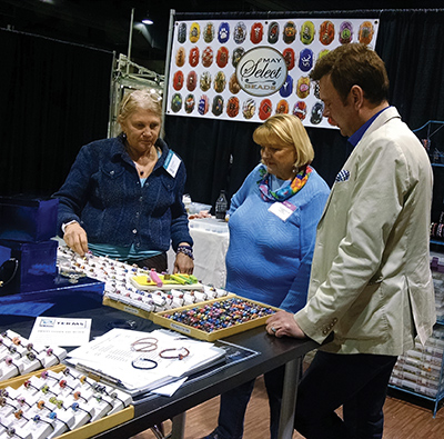 Kentucky Artisan Center at Berea Executive Director Todd Finley examines artwork at the  2017 Kentucky Crafted Market. Kentucky Crafted artists make up about 40 percent of the artists whose work is sold at the Artisan Center.