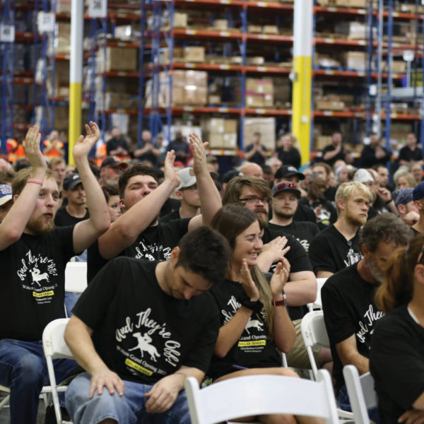 Employees cheer as company leaders and Kentucky Gov. Andy Beshear celebrate the grand opening of the Dollar General distribution center in Walton, a $65 million investment that created more than 300 new distribution and private fleet jobs